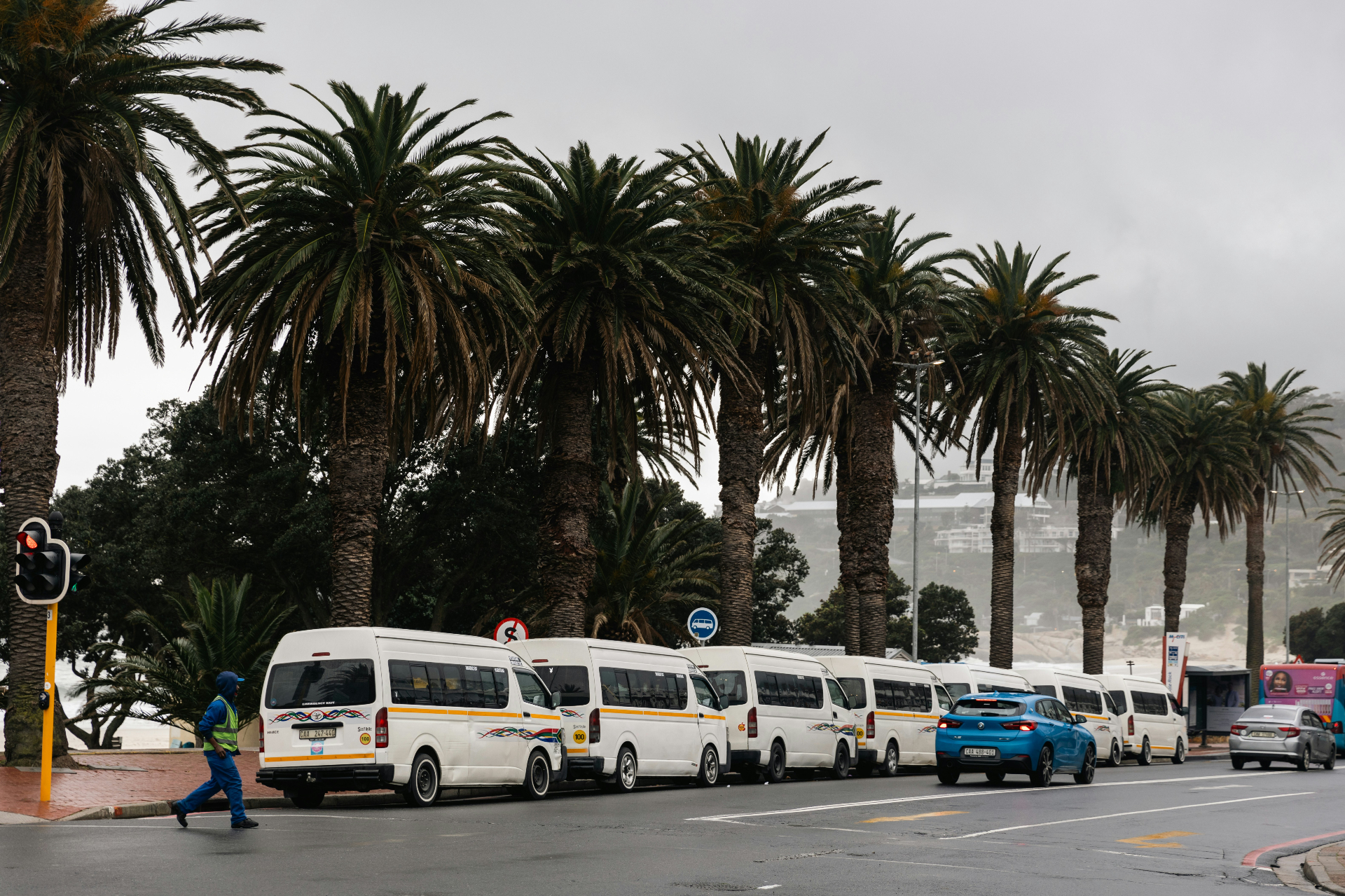 Commuters waiting at a Cape Town taxi rank in winter